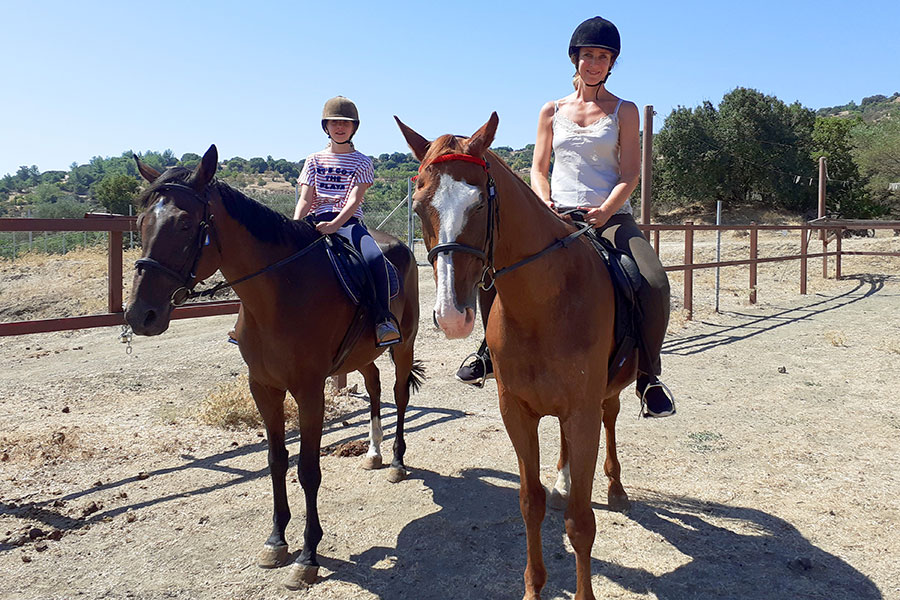 Photo of people riding horses