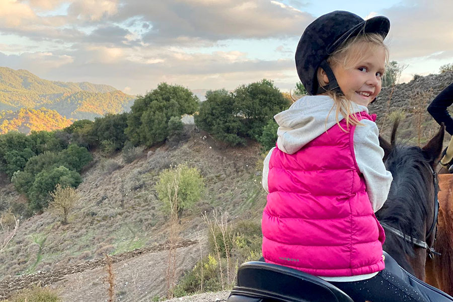 Photo of little girl riding a horse