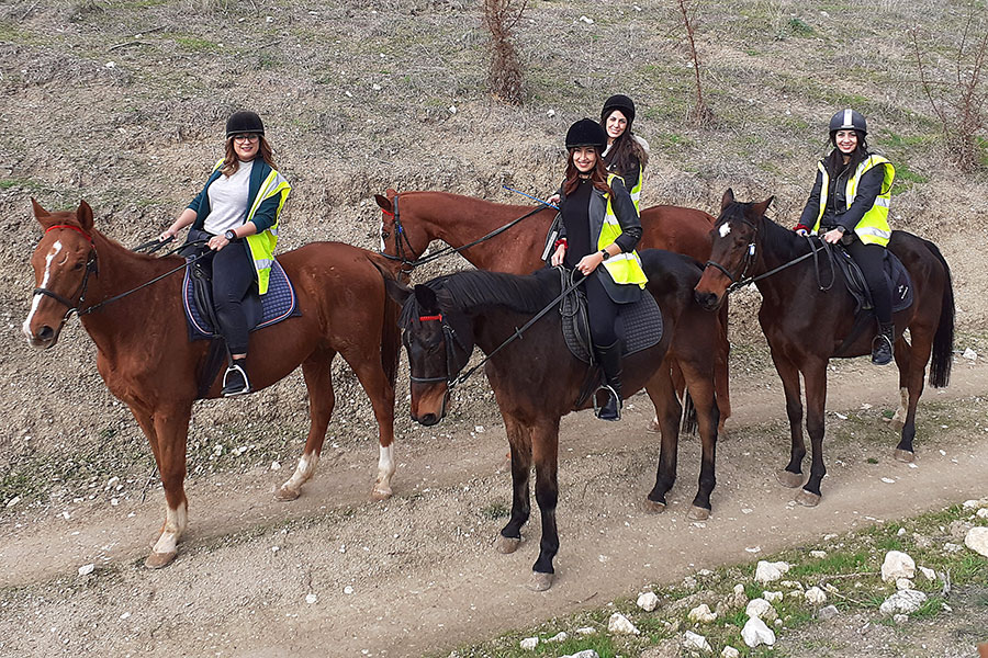 Photo of people riding horses