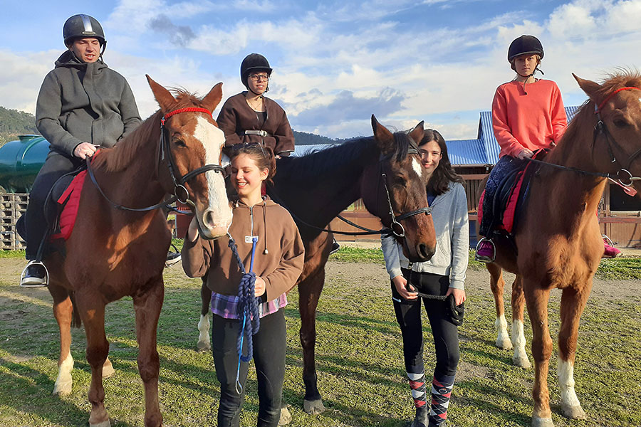 Photo of people riding horses