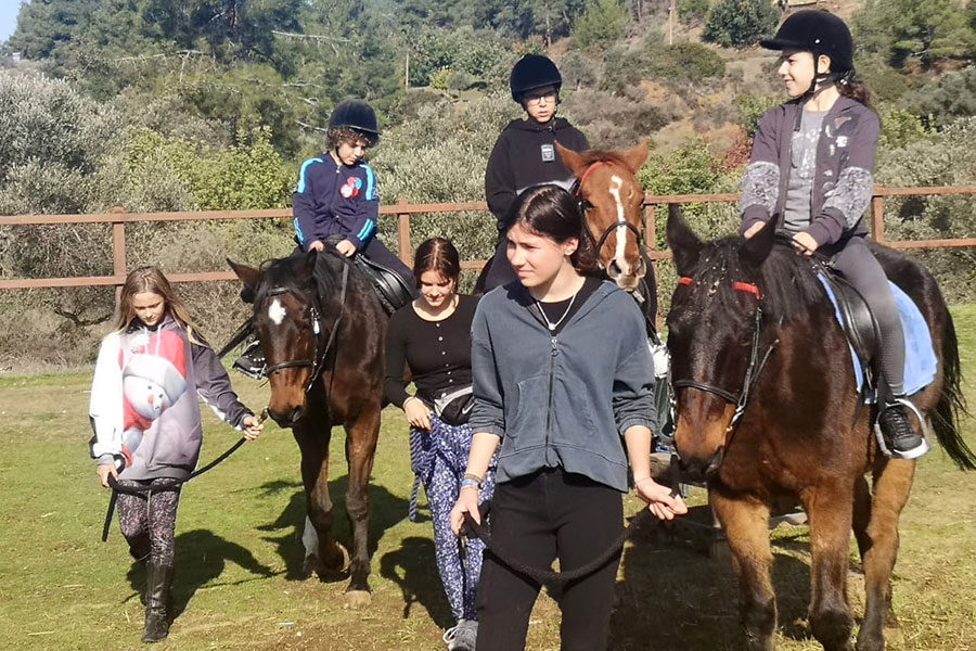 Photo of people riding horses