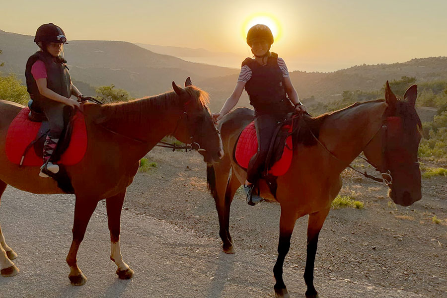 Photo of people riding horses