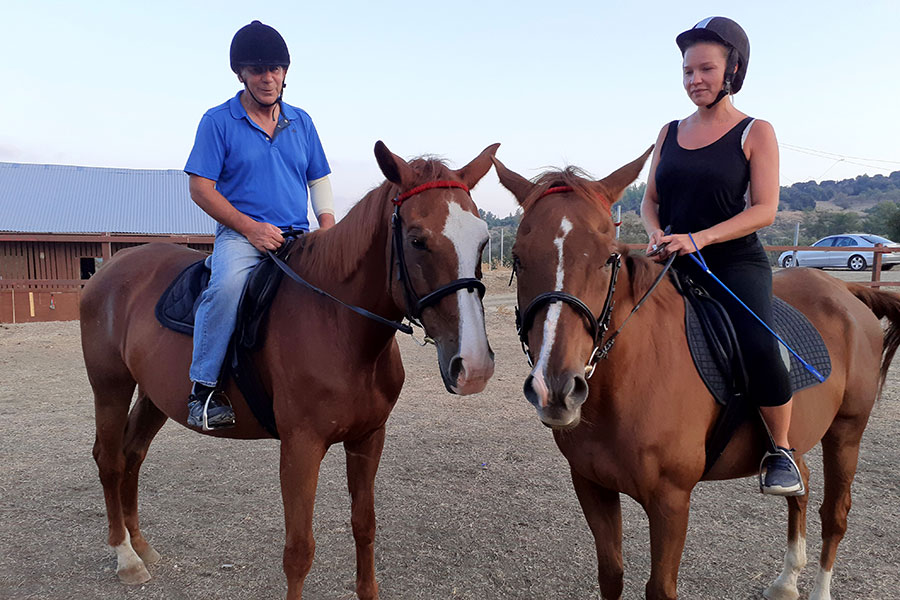 Photo of people riding horses